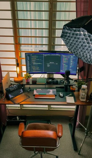 A clean and modern workspace featuring a laptop, tablet, smartphone, and monitor. Ideal for remote work and tech setups.